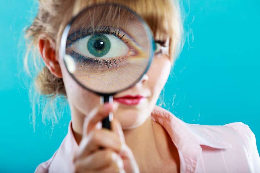 Woman Hand Holding Magnifying Glass On Eye