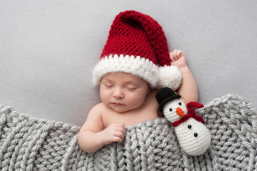A Sleeping Baby in a Santa Claus Hat