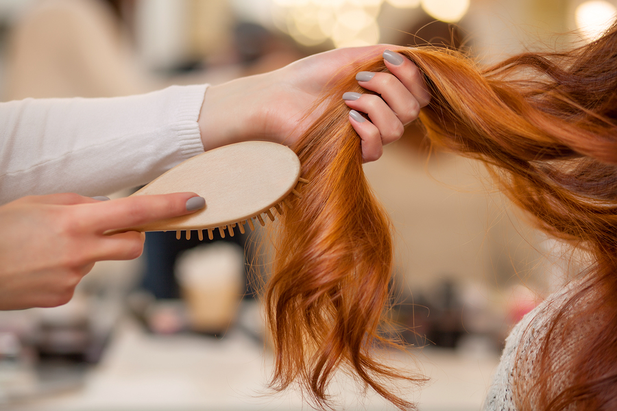 Hairdresser combing hair